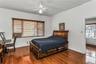 Bedroom featuring dark wood-style floors, a textured ceiling, and a ceiling fan