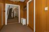 Hallway featuring a chandelier, stairs, and carpet flooring