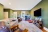 Living room with wood finished floors, recessed lighting, and a desk