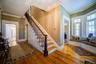 Stairway with crown molding and hardwood / wood-style flooring