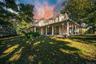 View of front of house featuring a porch, a chimney, and a front yard