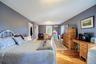 Bedroom featuring light wood-type flooring and a wall mounted AC