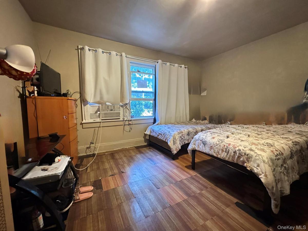 Bedroom with baseboards and wood finished floors