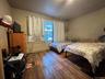 Bedroom with baseboards and wood finished floors