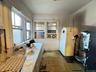 Kitchen with freestanding refrigerator and white cabinetry