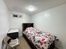 Bedroom with light tile patterned flooring and baseboards