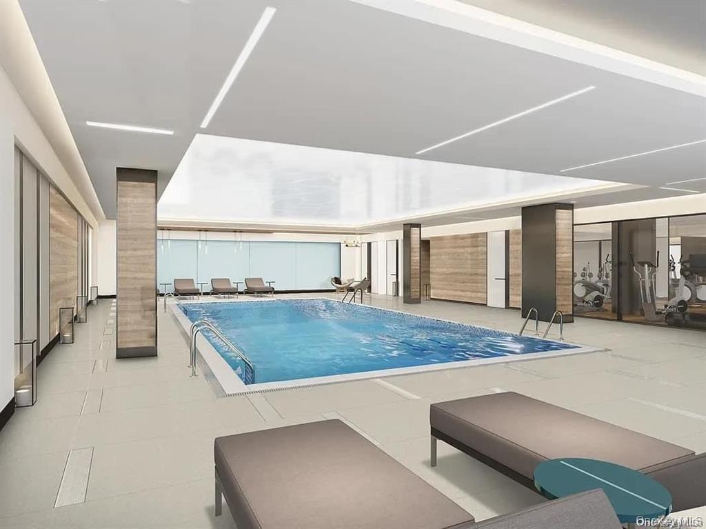 Indoor pool featuring a patio area