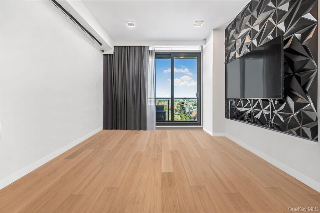 Unfurnished room featuring baseboards and wood finished floors