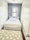 Bedroom with wood finished floors and baseboards