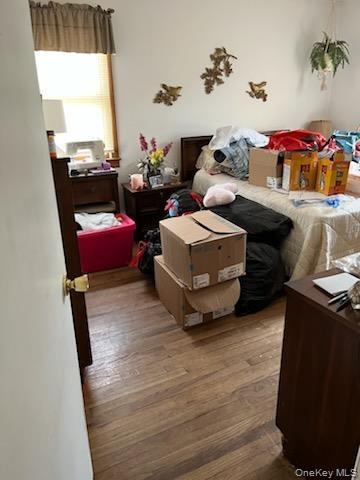 Bedroom with hardwood / wood-style flooring