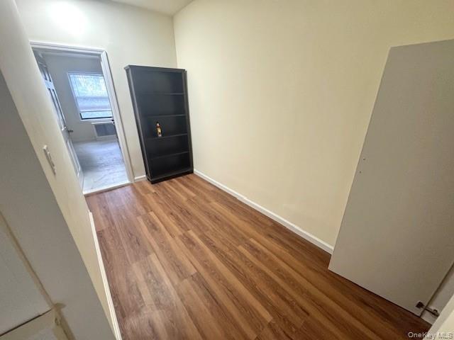 Hall featuring wood finished floors and baseboards