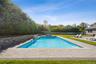 View of swimming pool with a patio and a fenced backyard