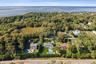 Aerial view of property and surrounding area with a nearby body of water
