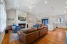 Living area featuring lofted ceiling, light wood-style floors, a fireplace with flush hearth, recessed lighting, and ceiling fan