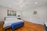 Bedroom with two closets, recessed lighting, wood finished floors, and a ceiling fan