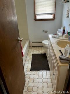 Bathroom with vanity and a baseboard heating unit