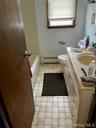 Bathroom with vanity and a baseboard heating unit