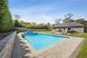 View of pool with a patio and a fenced backyard