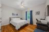 Bedroom featuring light wood finished floors and a ceiling fan