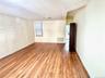 Empty room with light wood-style flooring and healthy amount of natural light