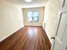 Unfurnished room with a textured wall, dark wood-type flooring, and a textured ceiling