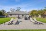Fenced backyard with a patio, an outdoor hangout area, and entry steps