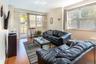 Living room with hardwood / wood-style floors and crown molding