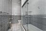 1st Floor Bathroom featuring tile walls, light tile patterned floors, tiled shower / bath, and radiator