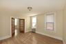 Empty room with french doors, wood finished floors, and radiator
