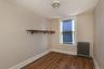 Unfurnished room with radiator and dark wood-type flooring