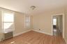 Spare room featuring radiator heating unit and light wood-style flooring