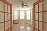 Large, bright bedroom with beautiful wood entrance doors