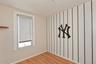 Unfurnished room with wood finished floors and healthy amount of natural light