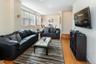 Living area with wood finished floors, baseboards, and crown molding