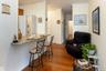Kitchen featuring a kitchen breakfast bar, dark wood-style floors, ornamental molding, baseboards, and light stone countertops