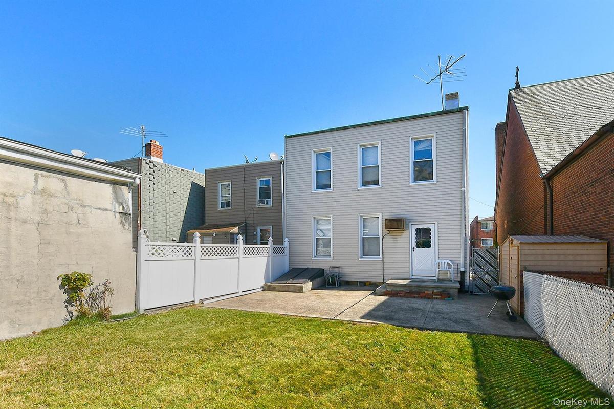 Rear view of property featuring a patio area and a fenced backyard
