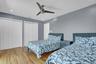Bedroom 4 with wood finished floors, two closets, ceiling fan, and recessed lighting