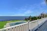 Wooden deck featuring a water view and a fenced backyard