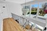 Stairway with hardwood / wood-style floors and baseboards