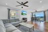 Living area featuring a wood stove, healthy amount of natural light, recessed lighting, and wood finished floors