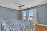 Bedroom 3  featuring a water view, wood finished floors, access to exterior, a ceiling fan, and recessed lighting