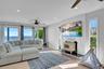 Living area featuring a ceiling fan, a wood stove, wood finished floors, and recessed lighting