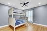 Bedroom 2 with light wood-style floors and a ceiling fan
