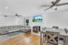 Living area featuring a ceiling fan, a wood stove, light wood finished floors, and recessed lighting