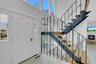 Entrance foyer with stairway and a high ceiling