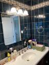 Bathroom featuring tile walls, vanity, and decorative backsplash