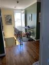Hallway featuring crown molding, an upstairs landing, and dark wood-style floors