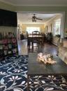 Living room with crown molding, dark wood-style floors, ceiling fan, and a baseboard radiator