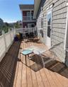 Wooden deck with outdoor dining space and cooling unit