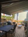 Wooden terrace with outdoor dining space and area for grilling